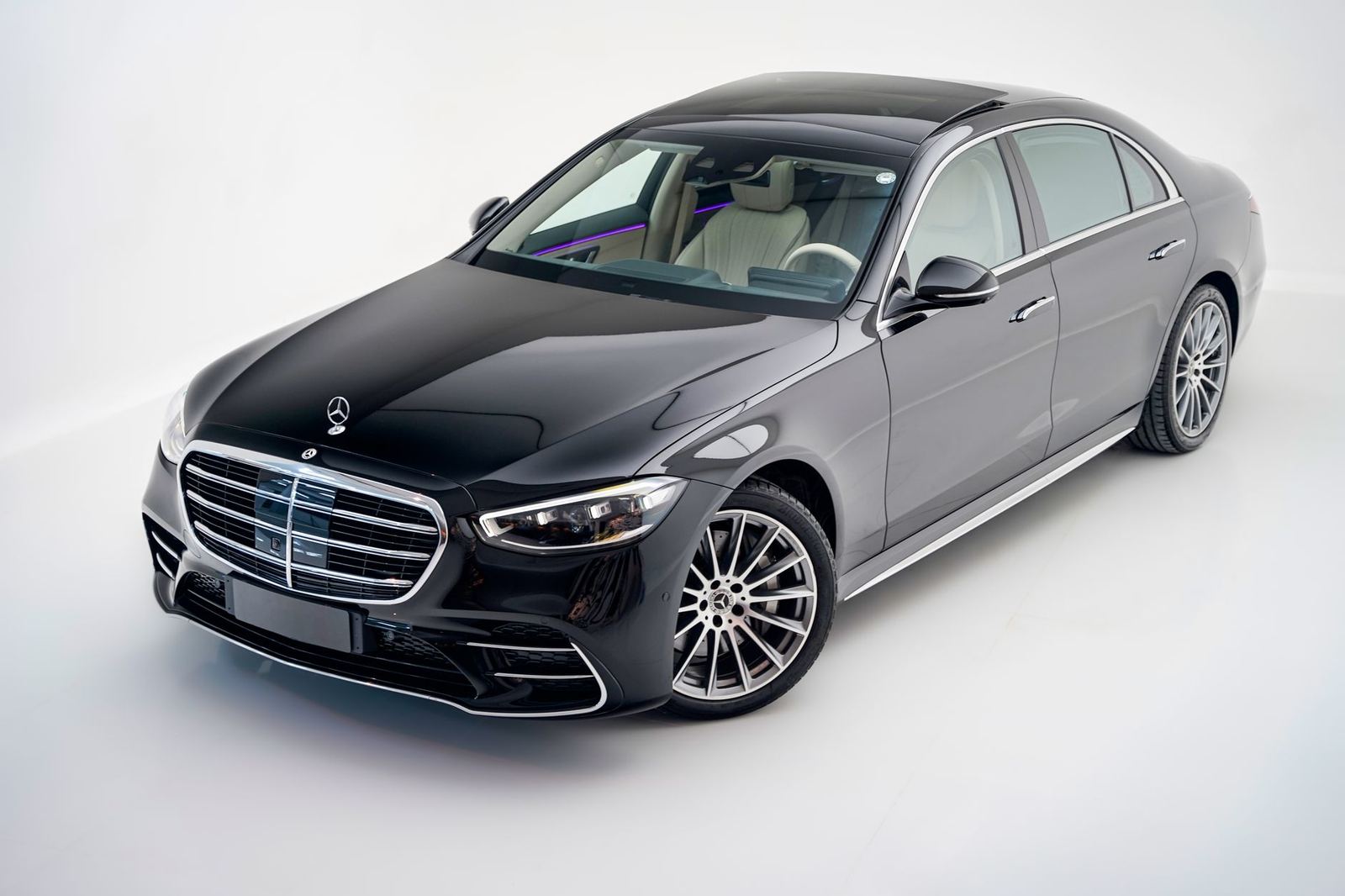 A new black Mercedes-Benz S-Class parked outside a showroom