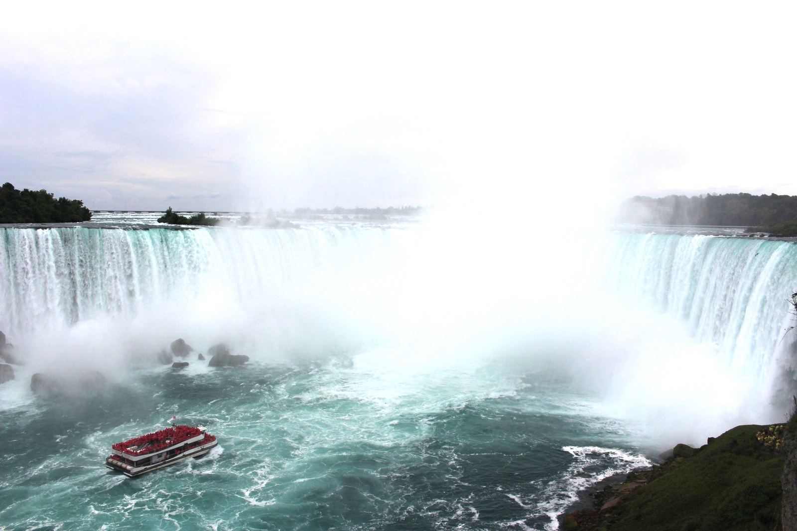Tour boat approaching Niagara Falls in the mist