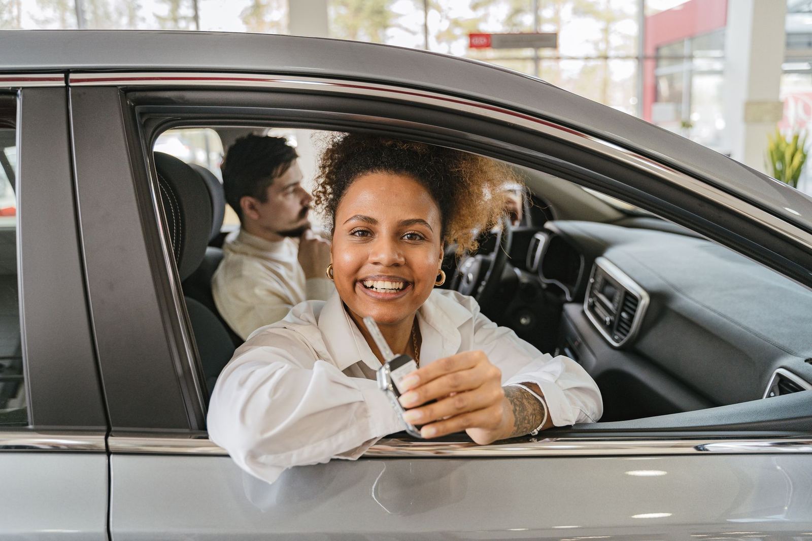Hand receiving car keys at a rental desk