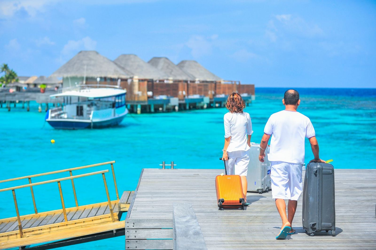 Couple with suitcases arriving in a hotel room